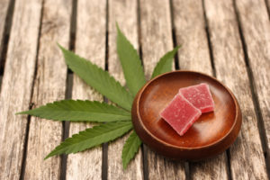 a dish of fast acting edibles placed on top of a cannabis leaf