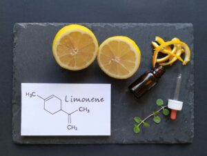 Up close look at the limonene terpene next to a vial and a half cut lemon.