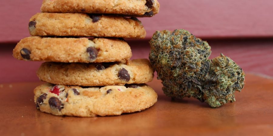 marijuana bud propped next to cookie edibles