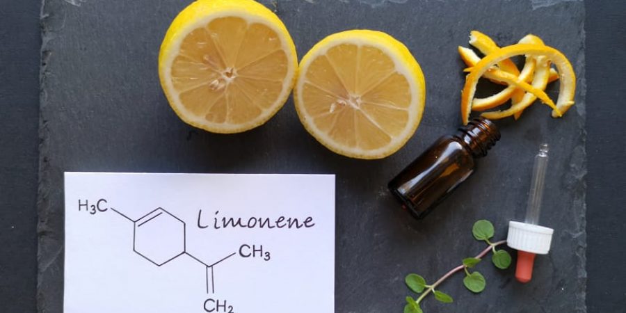 Up close look at the limonene terpene next to a vial and a half cut lemon.